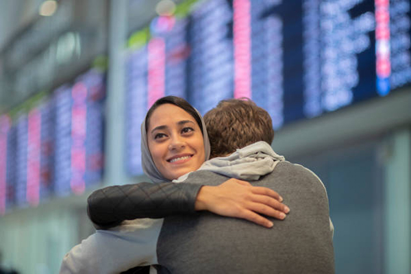woman and man hug in airport