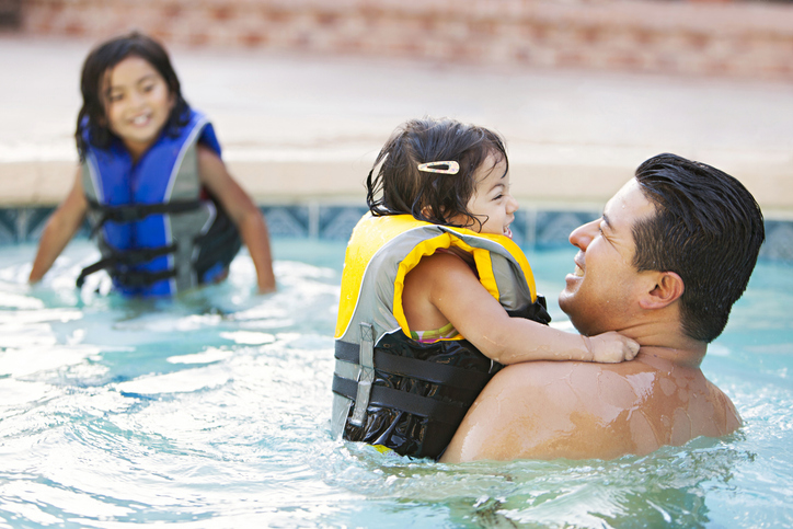 Father and child in swimming pool